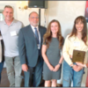 Jessica Karczeski (second from right), accepts her award with her parents, Northshore School District and WHS staff and Kimberly Ellertson, Woodinville Chamber Executive Director